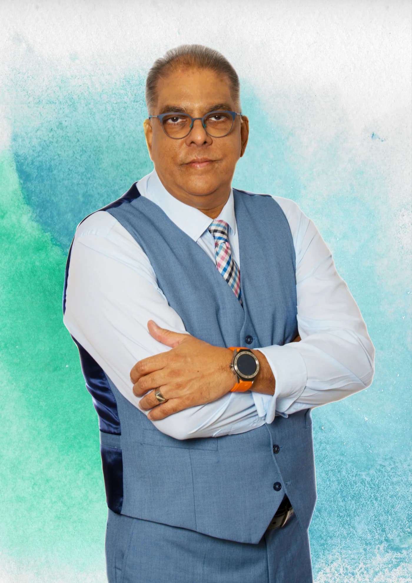 Dr RJ Sing in a blue waistcoat, arms folded, against a teal watercolour background